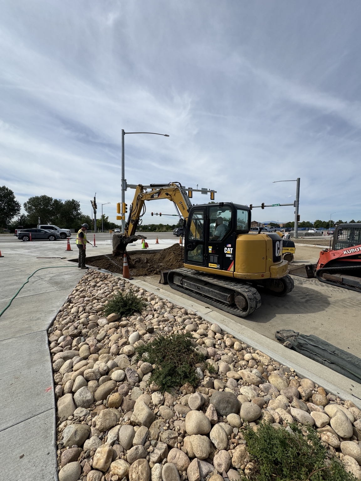 CAT excavator working at an intersection right-of-way